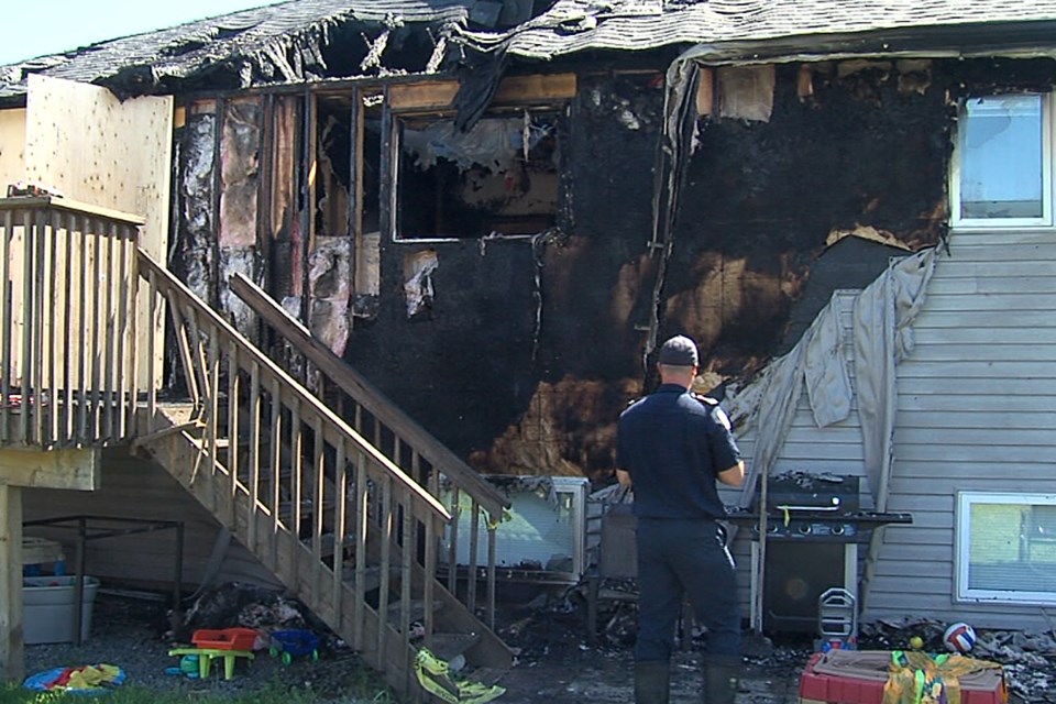 Thunder Bay Fire Rescue's Kevin Anderson on Wednesday, June 17, 2020 surveys the damage after a fire swept through the rear portion of a residence on Lexington Crescent. (Cory Nordstrom, Thunder Bay Television)