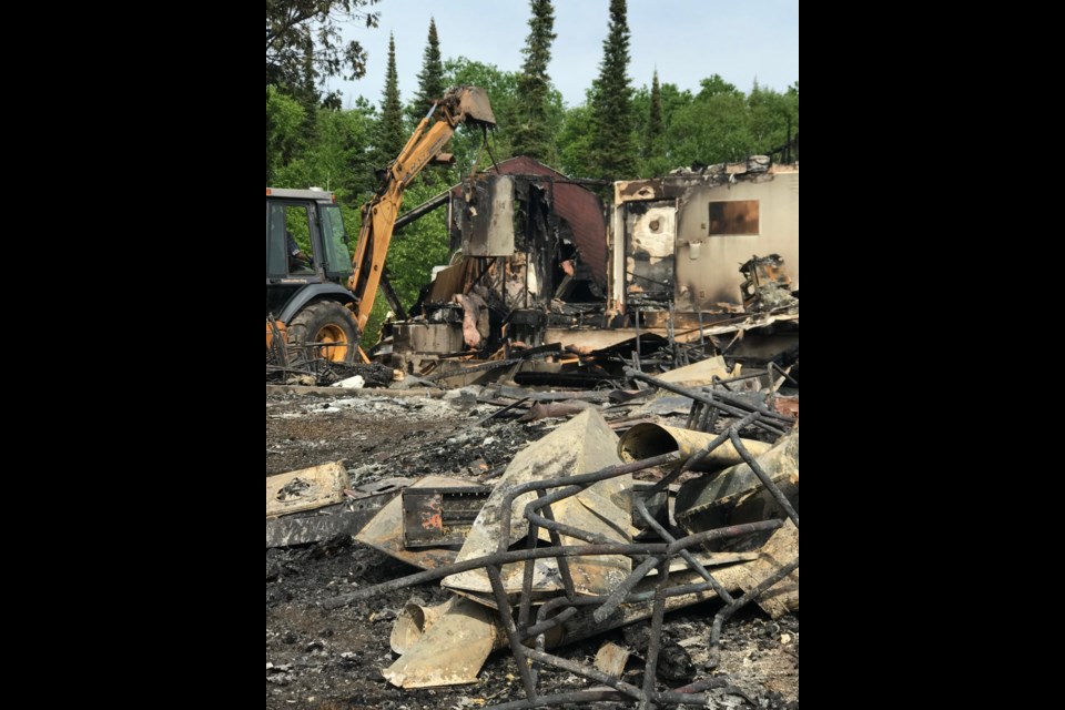 A backhoe was used to lift the filing cabinets from the basement of the ruined hall (courtesy June Huston)