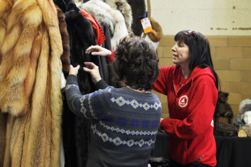 Katie Ball talks to a customer at her Silver Cedar Studio booth. (Photos by Ian Kaufman, tbnewswatch.com)