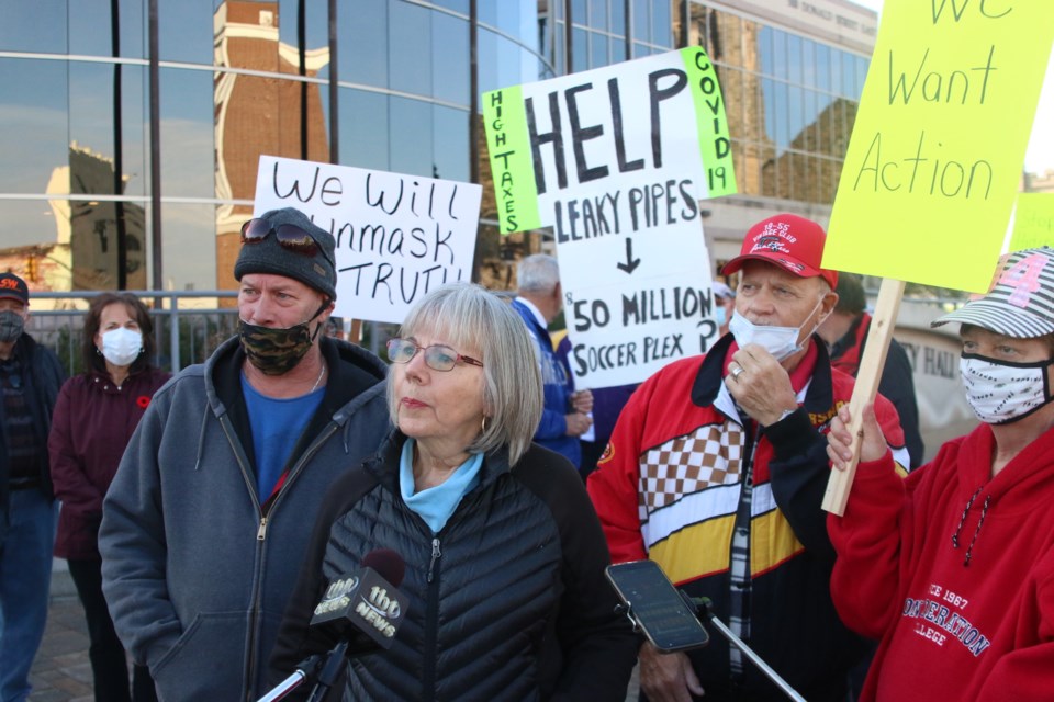 Dozens of people rallied outside Thunder Bay City Hall demanding action on the issue of leaking copper water pipes. 