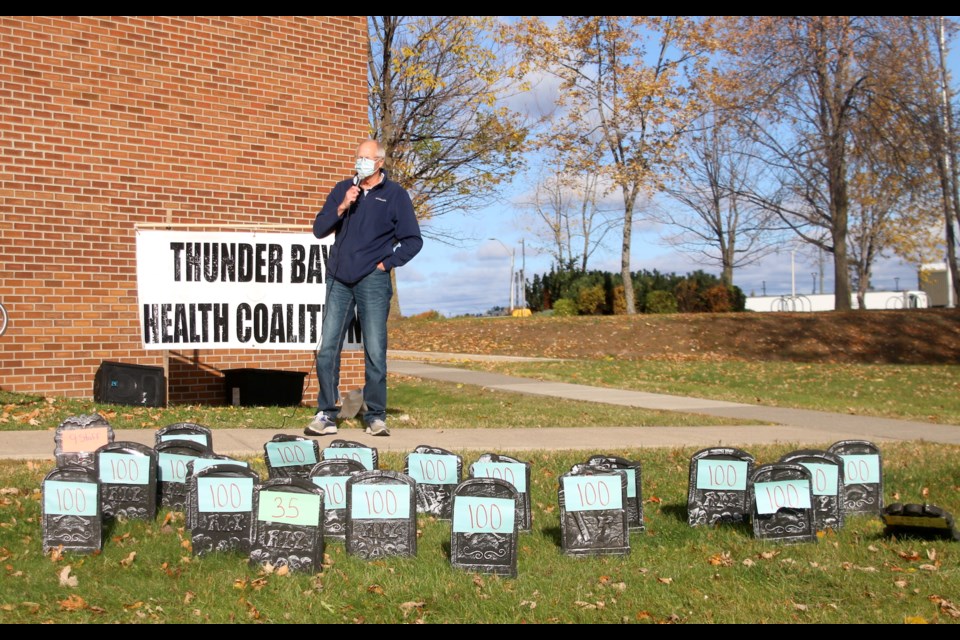 Jules Tupker, co-chair of the Thunder Bay Health Coalition, speaks during a rally at Mini-Queens Park on Thursday. (Photos by Doug Diaczuk - Tbnewswatch.com). 