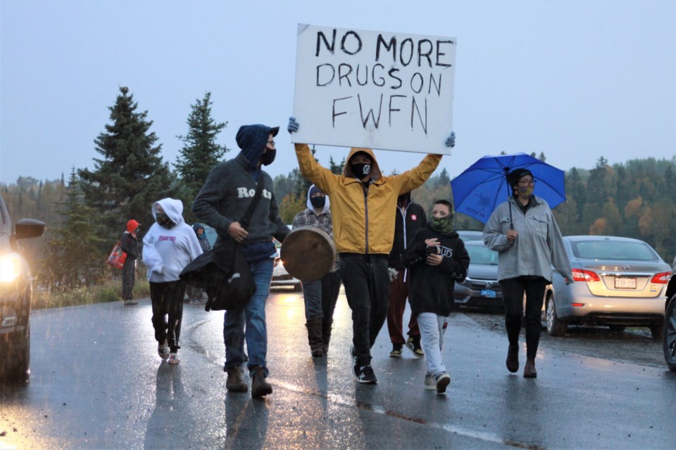 Beau Boucher-McLaren, pictured at left with a hand drum, leads an anti-drug walk Friday night on Fort William First Nation. (Ian Kaufman, tbnewswatch.com)