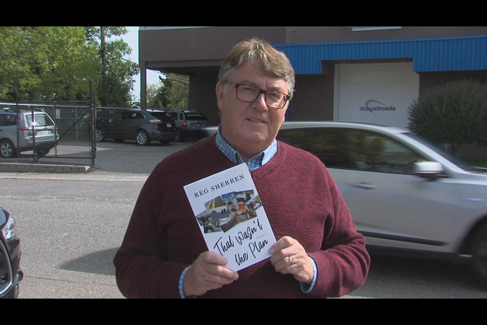 Veteran broadcaster Reg Sherren shows off his new memoir, That Wasn't the Plan. (Michael Mohorovich, TBT News)