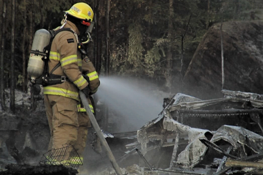 Responders put out a fire that destroyed a garage and trailer in Shuniah Friday evening. 