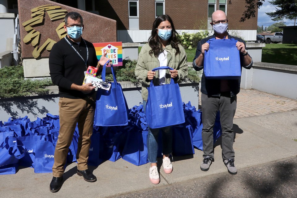 A.J. Keene (left) accepts donated school supplies on Wednesday, Sept. 2, 2020 at the Lakehead Public Schools office on Sills Street from Tbaytel representatives Bianca Kelo and Jamie Smith. (Leith Dunick, tbnewswatch.com)
