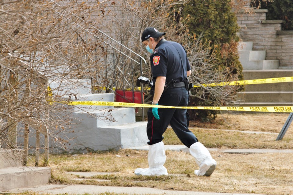 An officer with the Thunder Bay Police Service gathered evidence at an Alberta Street home Sunday afternoon. (Photos by Ian Kaufman, tbnewswatch.com)