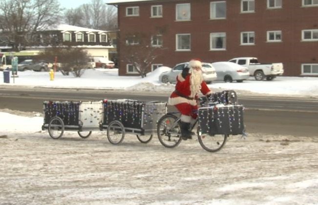 The latest variation of Westfort Santa's vehicle tows two carts decorated with Christmas lights