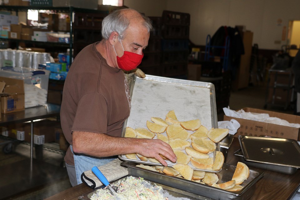 Volunteers help prepare and serve up food for up to 300 people each day at the Dew Drop Inn, wihch turns 40 in 2021. (Leith Dunick, tbnewswatch.com)