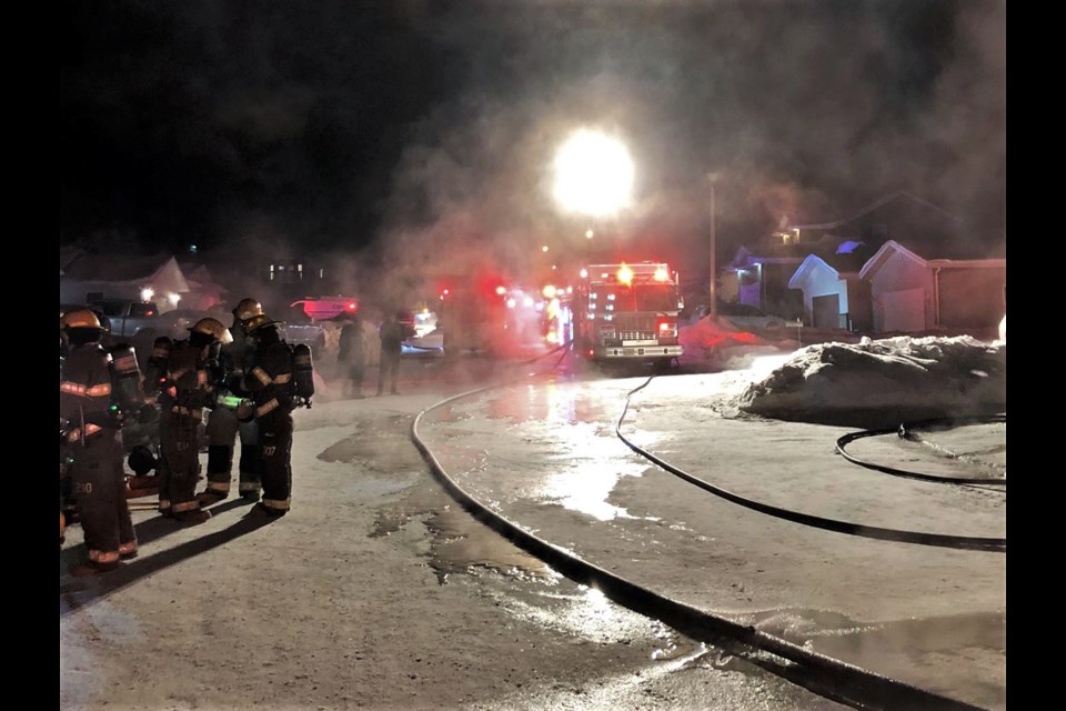 Firefighters respond to a blaze that destroyed a Dryden home and several vehicles Friday. (Dryden Fire Service)