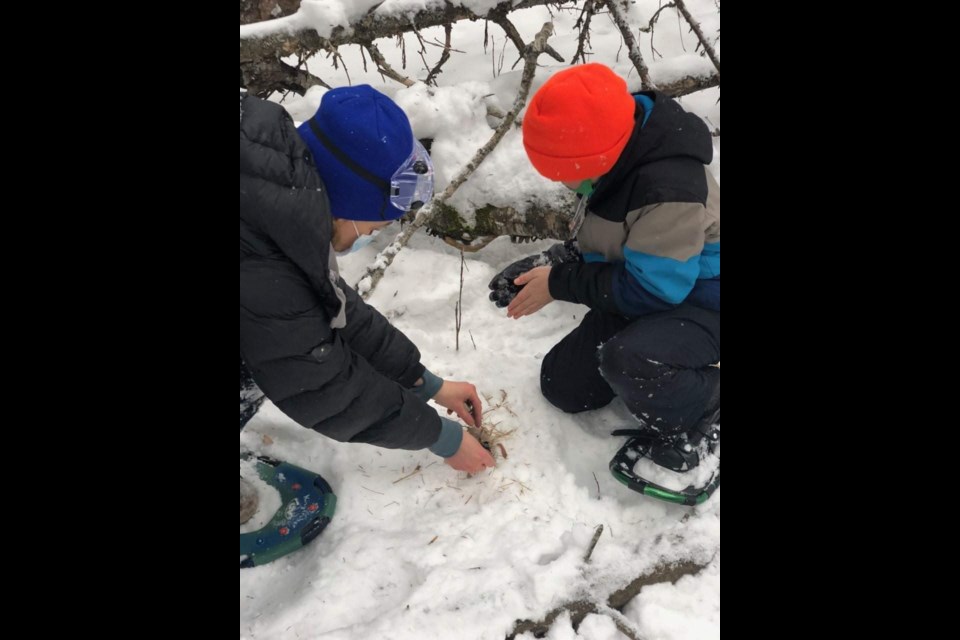 Lakehead Public Schools students practice traditional fire lighting with flint and steel during a Kingfisher-led activity. (Photo courtesy Lakehead Public Schools)