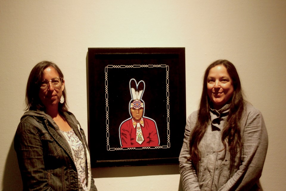 Leanna and Jean Marshall stand with a beaded portrait of  the late Jesse Gustafson (Justin Hardy/tbnewswatch.com)