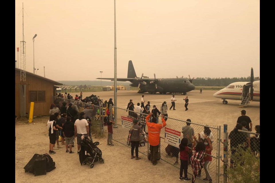 Poplar Hill First Nation residents prepare to evacuate on Sunday as a nearby forest fire threatens the community. (Photo courtesy Danno Moose)