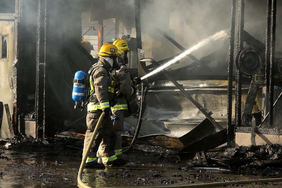 Firefighters battle a garage fire on Wednesday, March 3, 2021 at a West Arthur Street residence. (Leith Dunick, tbnewswathch.com)