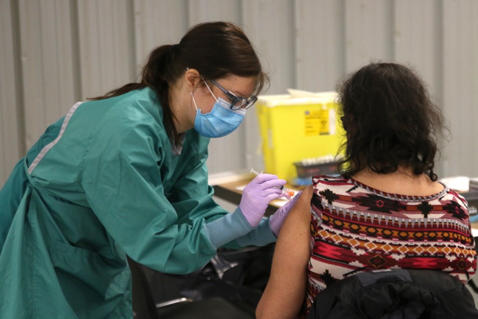 Deanna Zago, a registered nurse with Anishnawbe Mushkiki, administers a Moderna COVID-19 vaccine during a clinic held on Tuesday. (Photos by Doug Diaczuk - Tbnewswatch.com). 