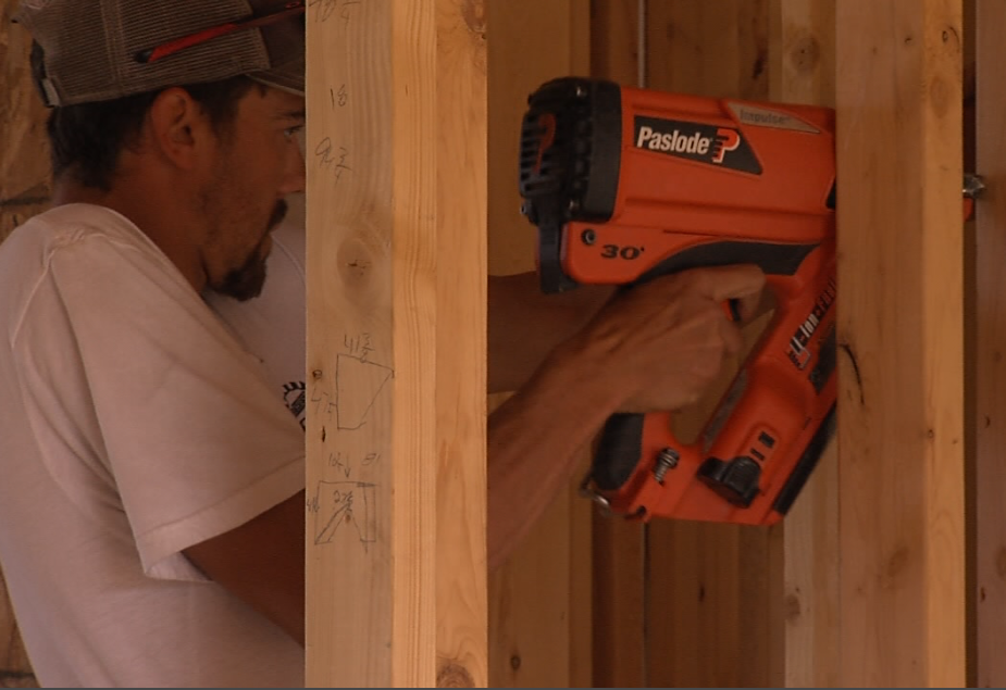 A worker uses an air nailer at a house construction site on the 15th Side Road on May 17, 2021 (Cory Nordstrom/TBTV photo) 