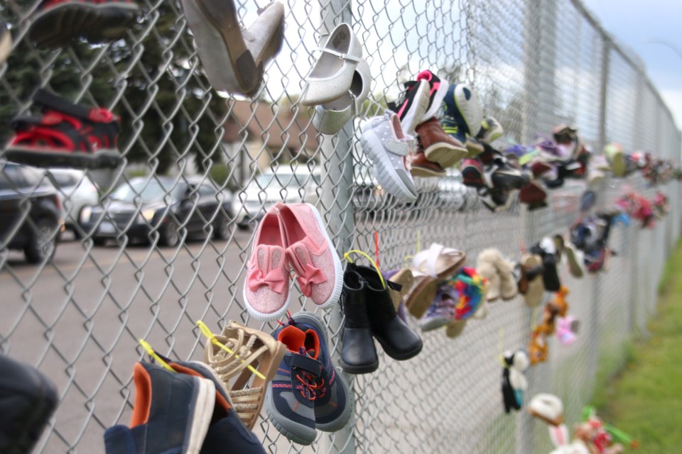 215 shoes were hung on the fence surrounding Pope John Paul II School, the former site of the St. Joseph's Residential School in memory of the remains of children discovered in Kamloops B.C. (Photos by Doug Diaczuk - Tbnewswatch.com). 