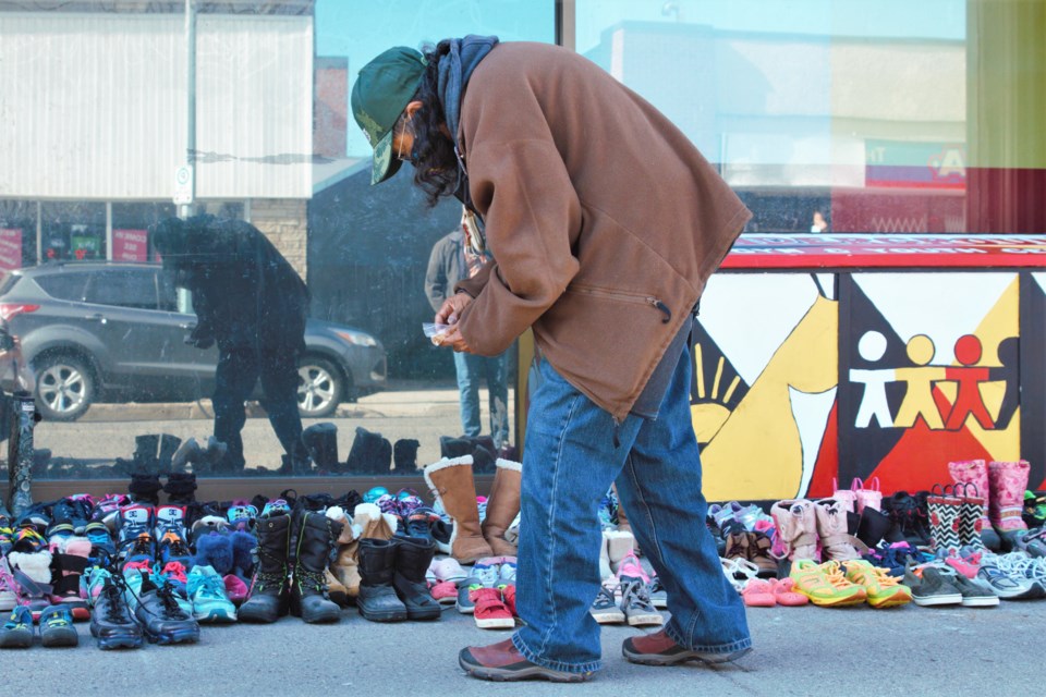 Ma-Nee Chacaby makes an offering to honour the victims of the Kamloops Indian Residential School. (Photos by Ian Kaufman, TBNewswatch)