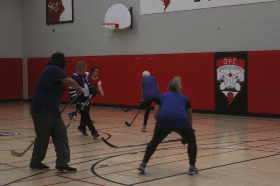 The Thunder Bay City Council, leadership from FWFN and leadership from the Thunder Bay Police Service play floor hockey with Students from Dennis Franklin Cromarty High school