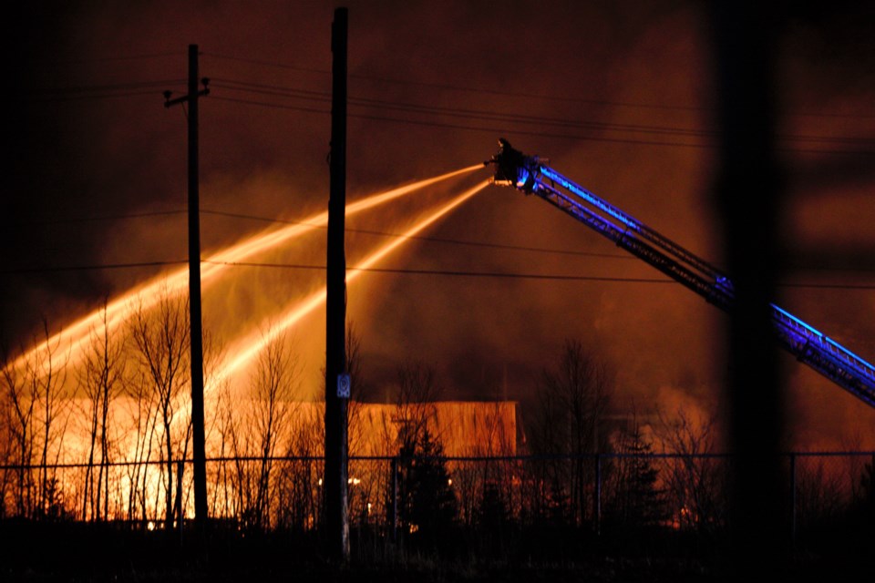 Firefighters battle a fire on Marina Park Drive Monday night. (Ian Kaufman, TBNewswatch)