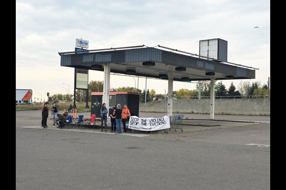 Members of the activist group Not One More Death staged an emergency action Friday over city plans to fence off a gas station at County Park frequented by the homeless.