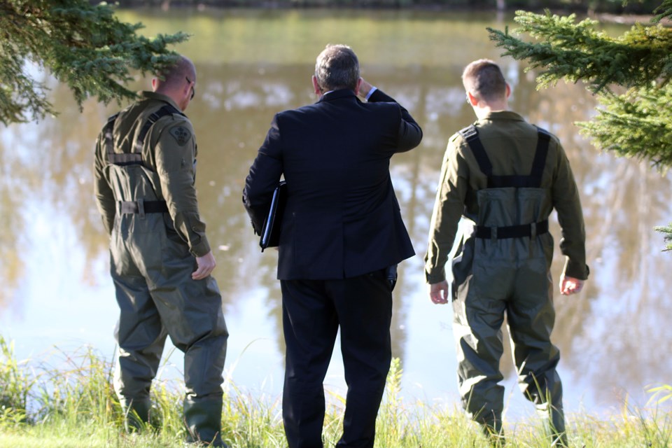 OPP Det.-Insp. Shawn Glassford (centre), looks at the McIntyre River on Tuesday, Oct. 19, 2021. He is leading a re-investigation into the 2015 death of Stacy DeBungee, an Indigenous man  (Leith Dunick, tbnewswatch.com)