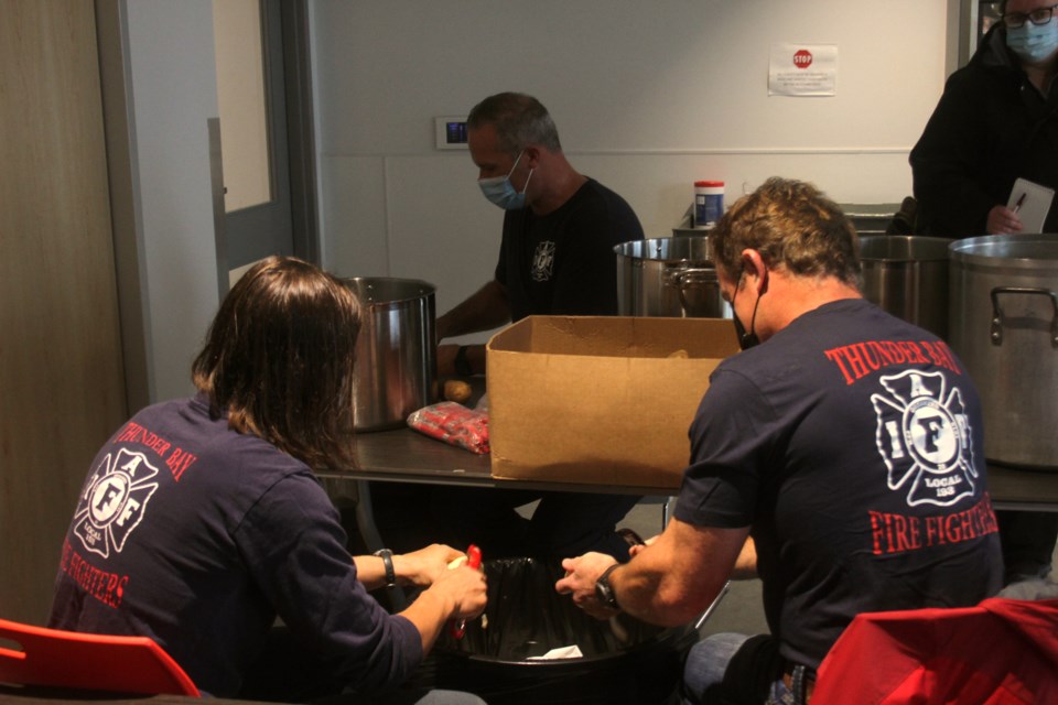 Thunder Bay firefighters peeling potatoes