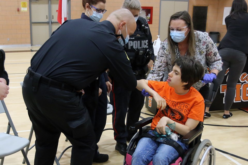 Mia Gaudette-Therrien, helped by Leanne Lawson is congratulated for receiving a Special Olympics School Team award on Tuesday, Oct. 19, 2021. (Leith Dunick, tbnewswatch.com)