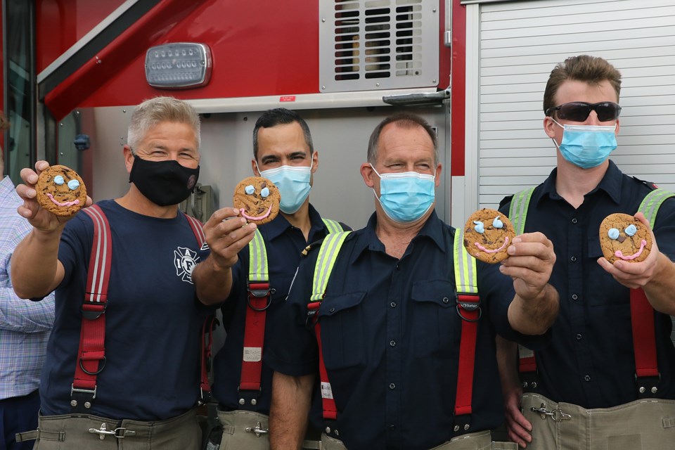 Thunder Bay Professional Firefighters Association members on Monday, Sept. 13, 2021 help launch the annual Smile Cookie campaign in the city. (Leith Dunick, tbnewswatch.com)
