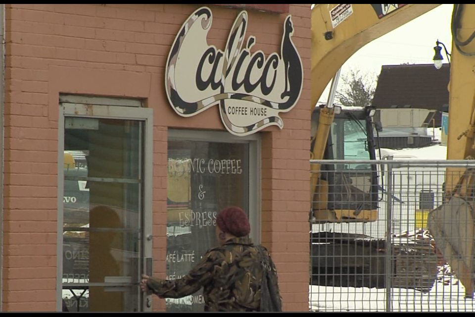 A customer enters Calico Coffee House on Apr. 4, 2022 after it opened its door for the first time in over three months (Leigh Nunan/TBTV)