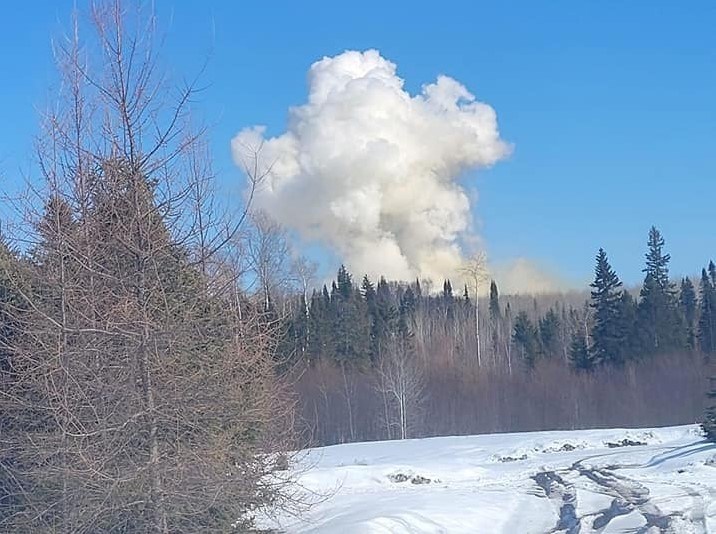 An image shows a cloud of dust and smoke rising from the quarry on Copenhagen Road where a large blast occurred Tuesday. (Facebook)