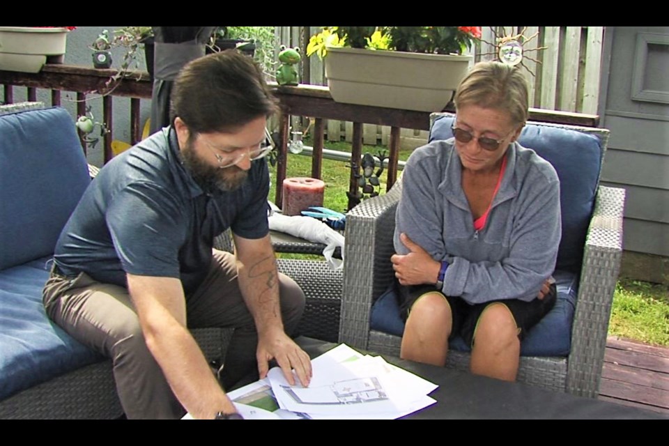 Jodi Graham, left, reviews plans for a backyard home on her Westfort property with architectural technologist Jeremiah Gammond. (Vasilios Bellos)