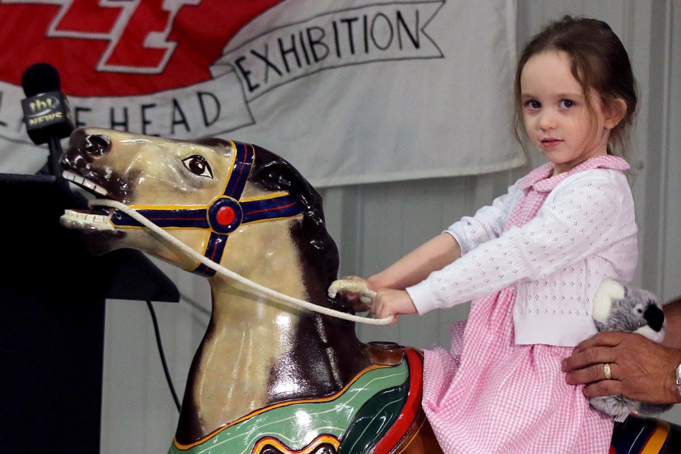 Four-year-old Avilene tests out a pony ride on Wednesday, July 6, 2022 at a news conference detailing this year's Canadian Lakehead Exhibition. (Leith Dunick, tbnewswatch.com)