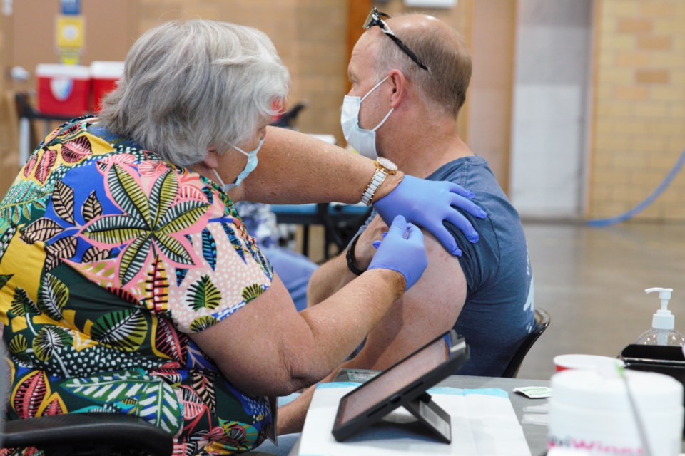 A nurse administers a COVID-19 vaccine dose at the CLE clinic run by the Thunder Bay District Health Unit on Thursday. (Ian Kaufman, TBnewswatch)