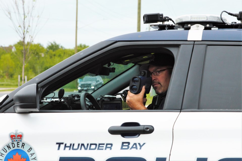 Const. Jeff Carlson uses LIDAR to monitor speeds along Junot Avenue during a traffic enforcement blitz on Tuesday. (Ian Kaufman, TBnewswatch)