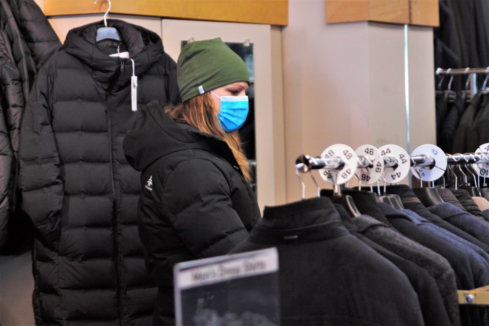A customer browses racks at J.B. Evans in Westfort. Masks will be optional in Ontario stores beginning March 21. (Ian Kaufman, TBNewswatch)