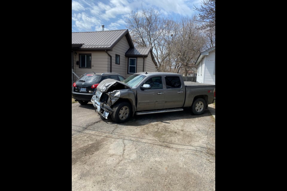Area residents say the truck pictured collided with multiple vehicles and a home on Kenogami Avenue around 1 p.m. Tuesday. (Submitted photo)