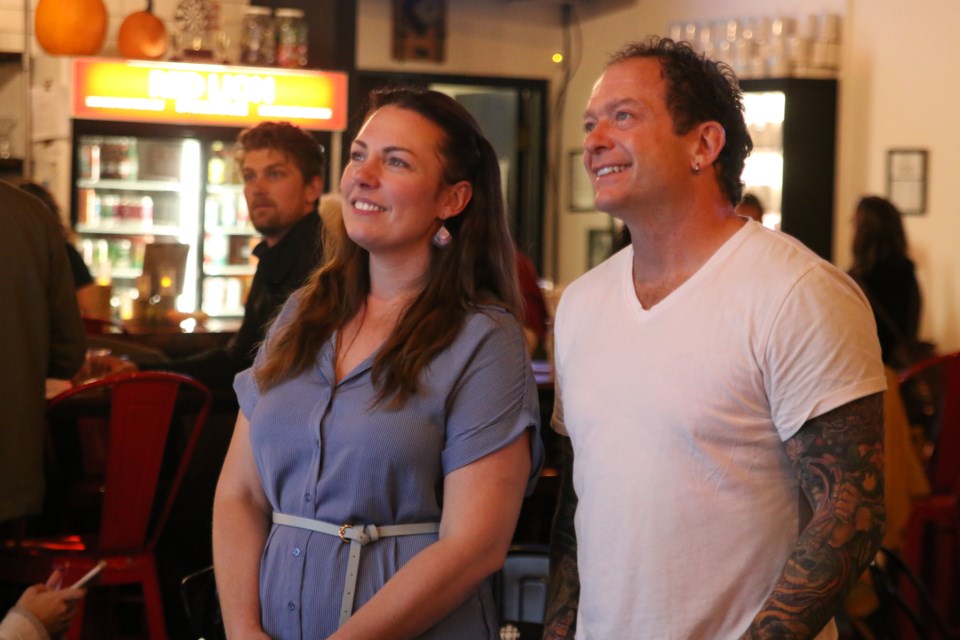 Brian Hamilton and Shelby Ch'ng watch the results come in on election night. 