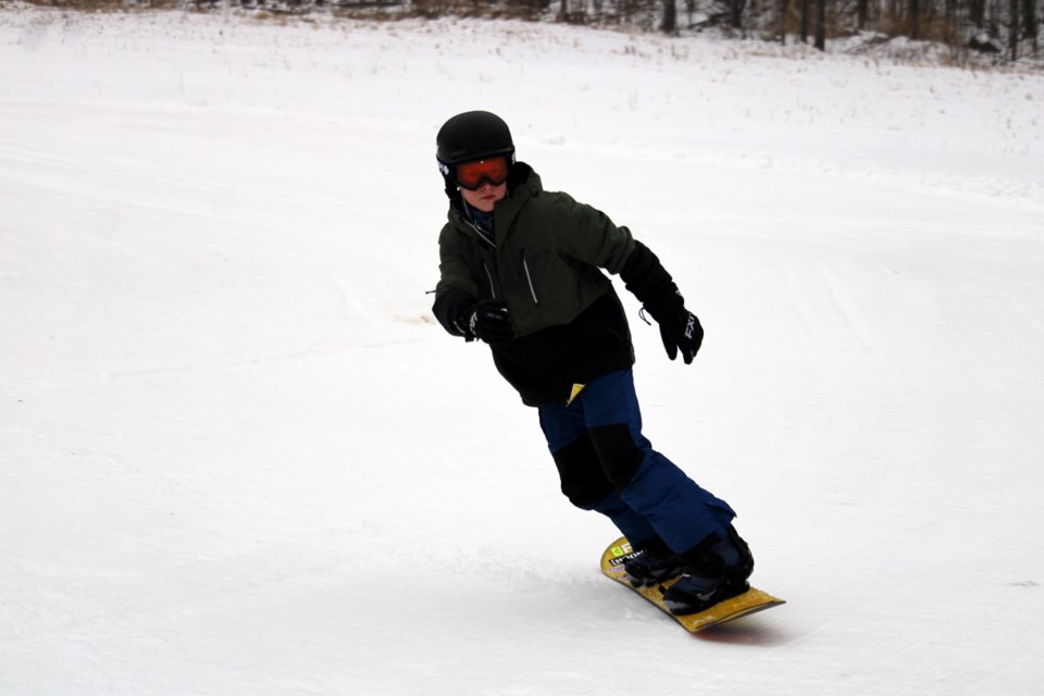 Skiers and snowboarders hit the slopes at Loch Lomond Ski Area on Friday.