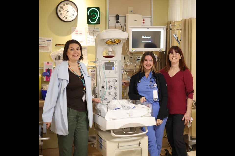 Regional hospital staff with a NICU infant warmer