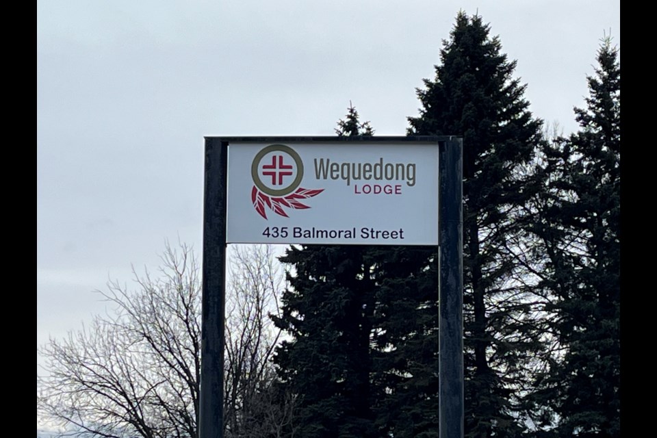 The sign outside of the Wequedong Lodge of Thunder Bay