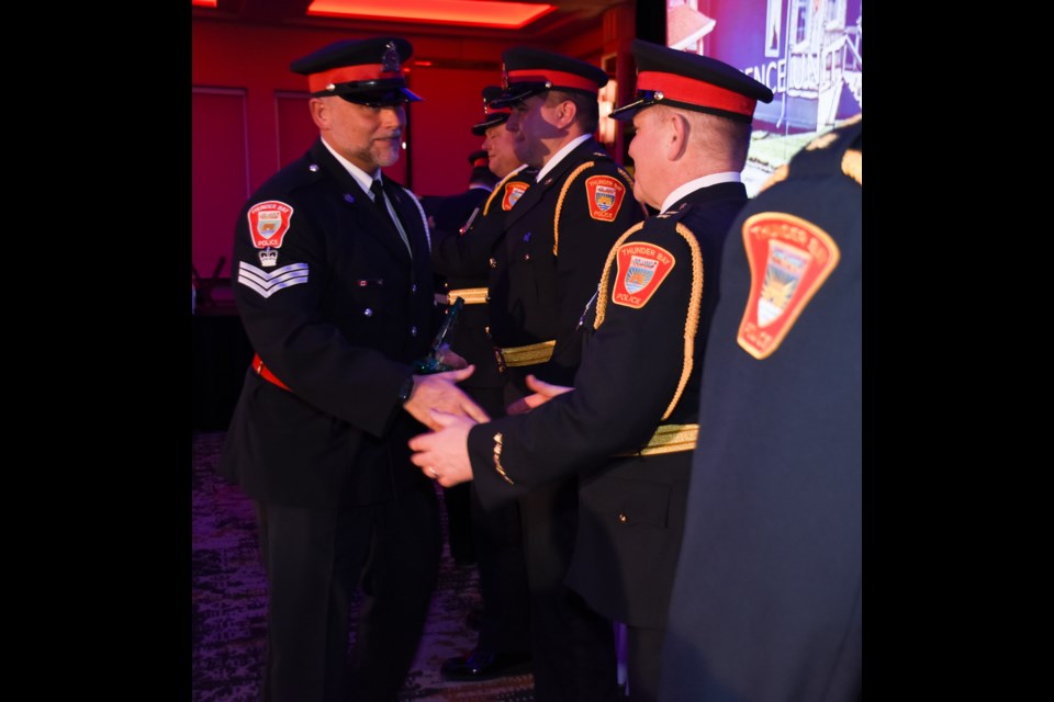 Staff Sgt. Dan Irwin shakes hands with senior officers while accepting a unit accommodation for his work within the intelligence unit. (Submitted photo)