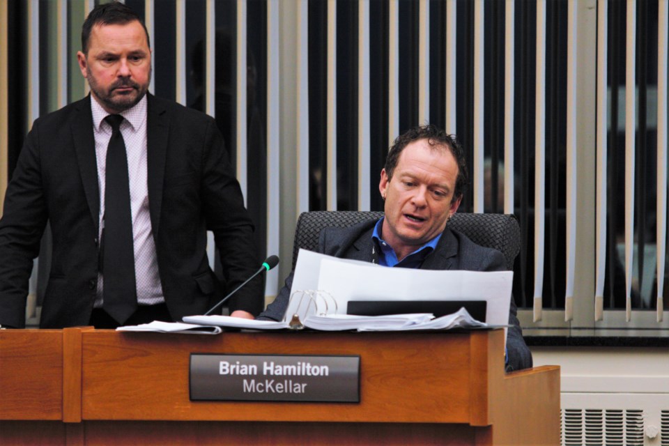 Coun. Brian Hamilton (right) proposes budget changes on Tuesday as Coun. Trevor Giertuga looks on. Both voted to find savings through staffing and service cuts. (Photos by Ian Kaufman, TBnewswatch)