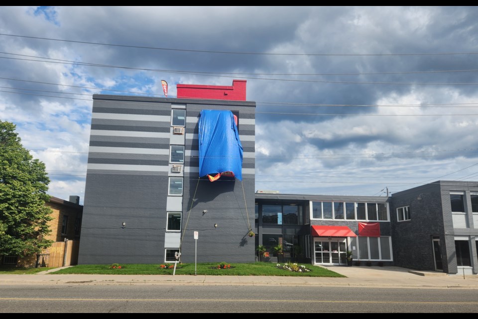 Until the restaurant and bar open, a tarp will cover the "Aiden by Best Western" sign on a newly renovated hotel on Cumberland Street North in Thunder Bay. (TBnewswatch)