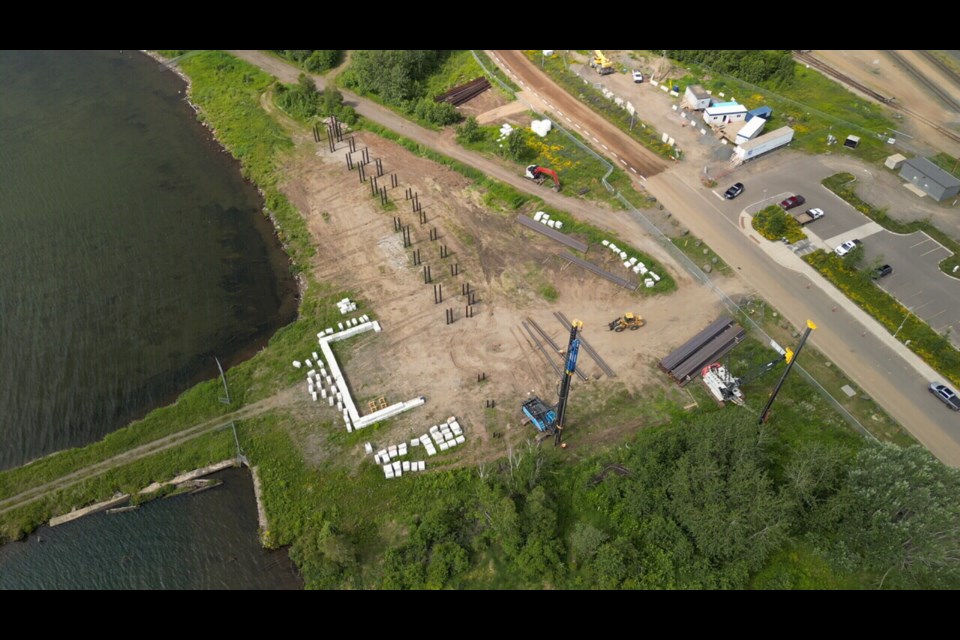 An overhead view shows crews with Tom Jones beginning pile-driving work at the Thunder Bay Art Gallery's new waterfront location in July 2023. (TBT News)