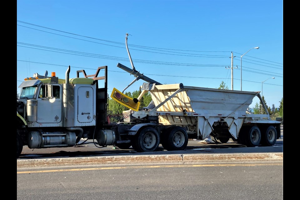 A transport truck involved in the collision also collided with a traffic signal. (TBnewswatch photo)