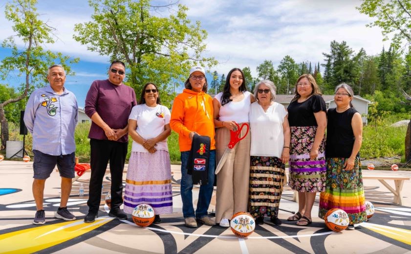 Dignitaries gathered with Emily Mandamin (4th from right) to celebrate the refurbishment of the basketball court at Iskatewizaagegan # 39 Independent First Nation (submitted photo)
