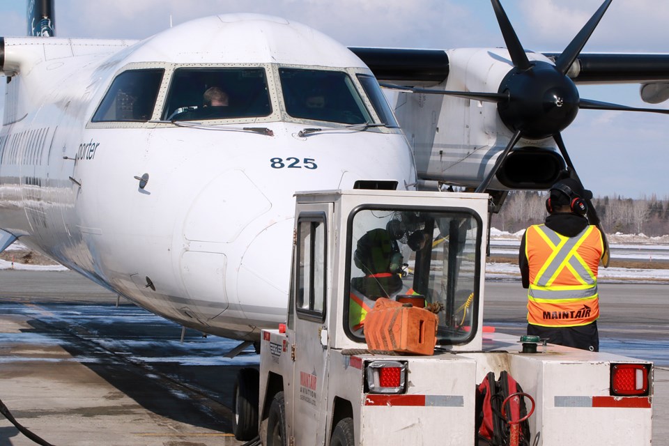 Crews at Thunder Bay Airport prepare Porter Airlines inaugural direct flight to Ottawa from Thunder Bay for takeoff, on Monday, March 27, 2023. (Leith Dunick, tbnewswatch.com)