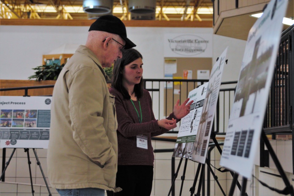 Alison Barrett, municipal engineer at KGS Group, right, speaks with Westfort resident Dale Lindsey at Wednesday’s Victoriaville open house. (Ian Kaufman, TBnewswatch)