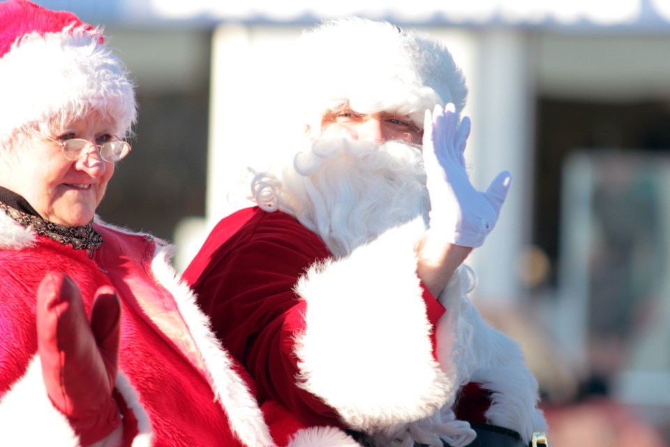 Santa Claus and Mrs. Claus wave during Saturday's parade.