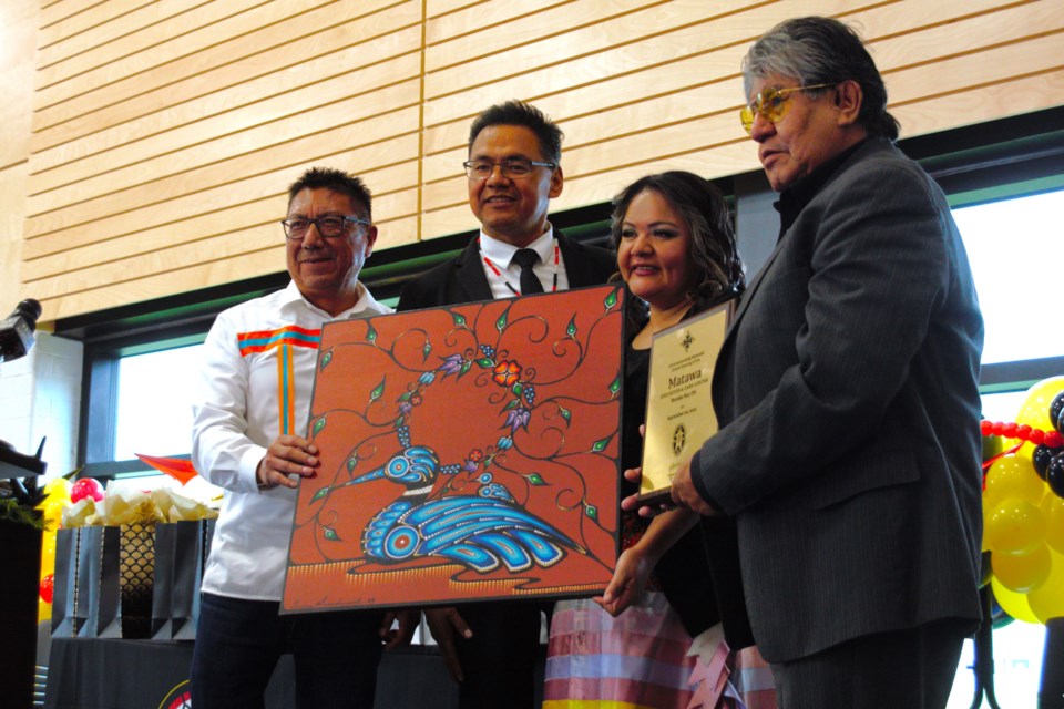 From left, NAN Grand Chief Alvin Fiddler and Deputy Grand Chief Bobby Narcisse present Matawa education executive director Sharon Nate and CEO David Paul Achneepineskum with a gift to mark the grand opening.